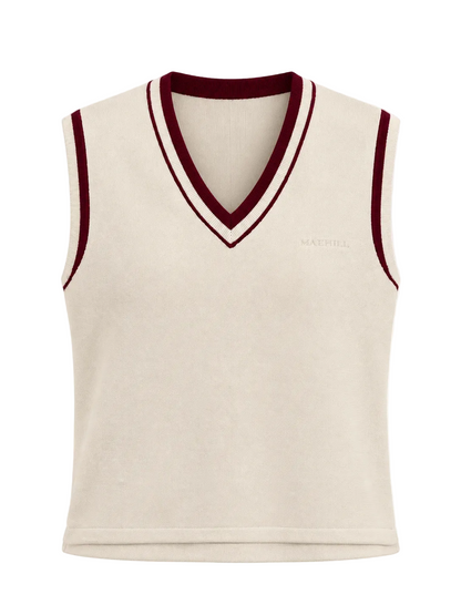 MAEHILL cream knit sweater vest with a V-neck, featuring burgundy and white striped trim and an embroidered logo.